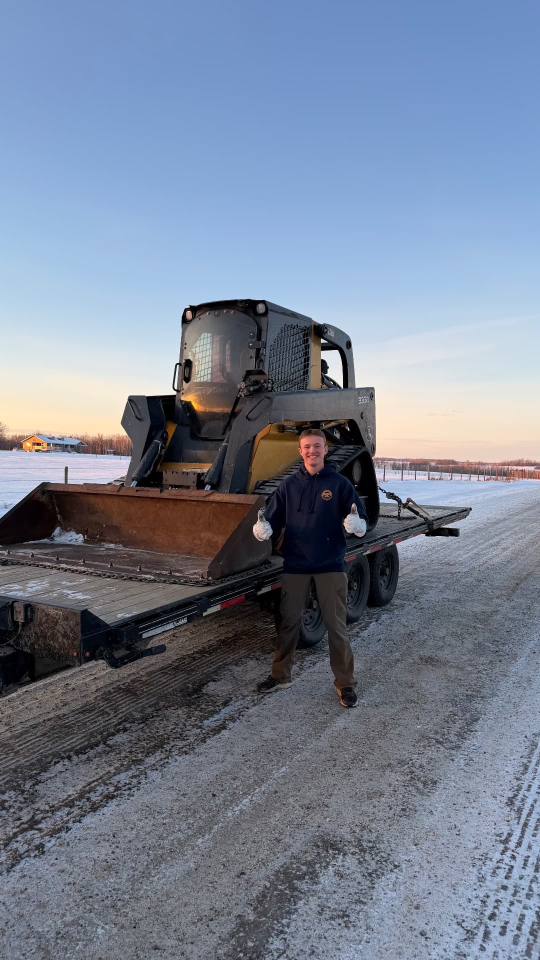 Owner-operator with the skid steer loaded on the trailer